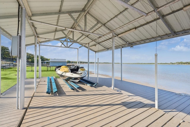 dock area with a water view and a lawn