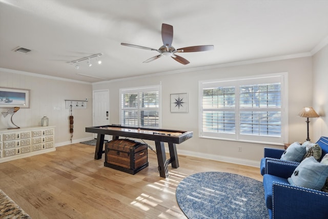 recreation room with light hardwood / wood-style flooring, ceiling fan, rail lighting, and crown molding