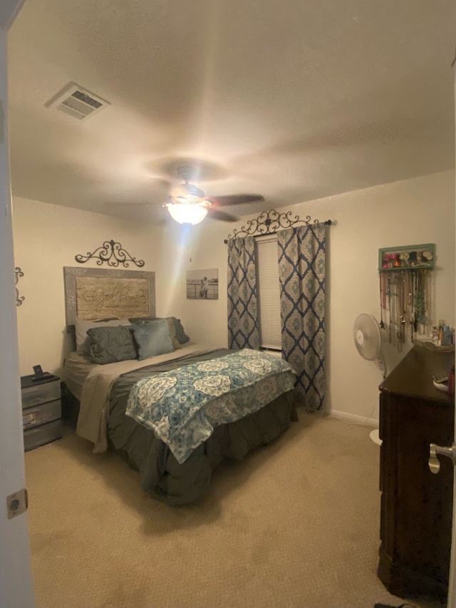 bedroom with ceiling fan and light carpet