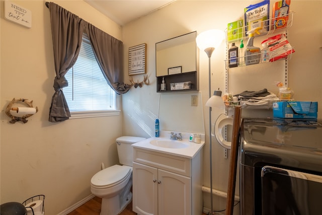 bathroom featuring vanity, toilet, and hardwood / wood-style floors