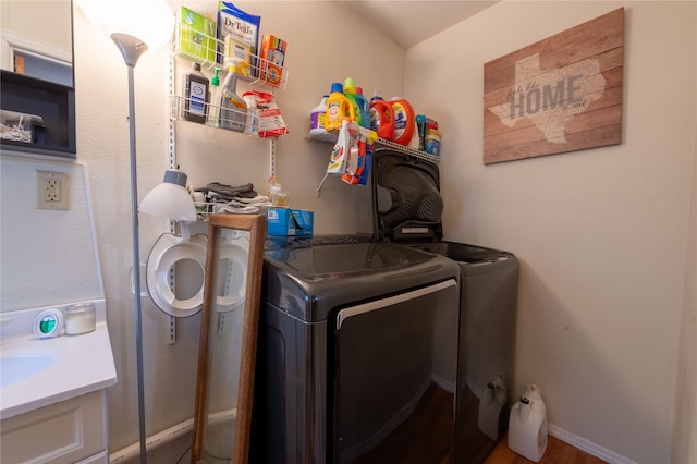 laundry area featuring wood-type flooring and washer and clothes dryer