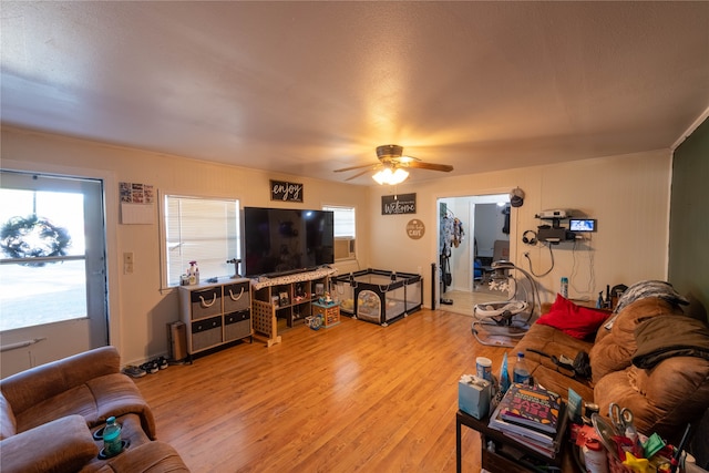 living room with wood-type flooring and ceiling fan