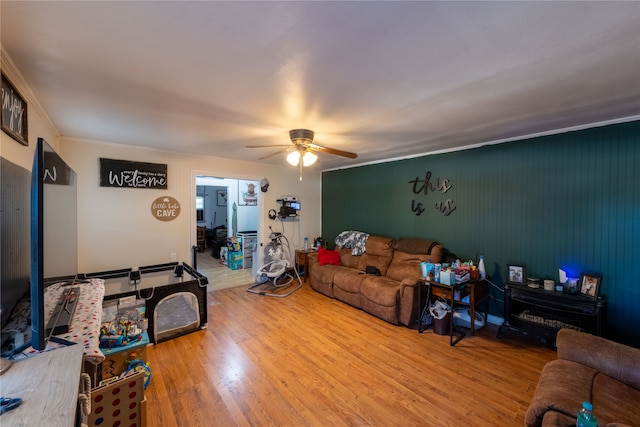 living room with ornamental molding, hardwood / wood-style floors, and ceiling fan