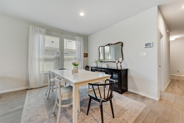 dining space with light hardwood / wood-style flooring