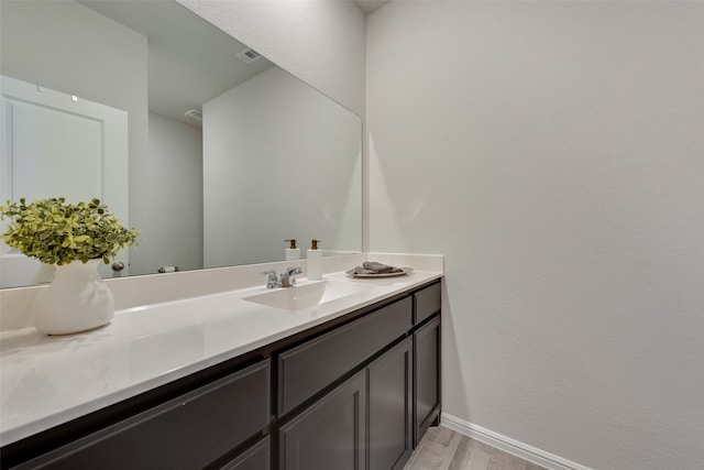 bathroom featuring vanity and hardwood / wood-style flooring