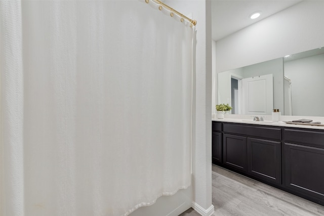 bathroom featuring vanity, hardwood / wood-style floors, and shower / tub combo with curtain