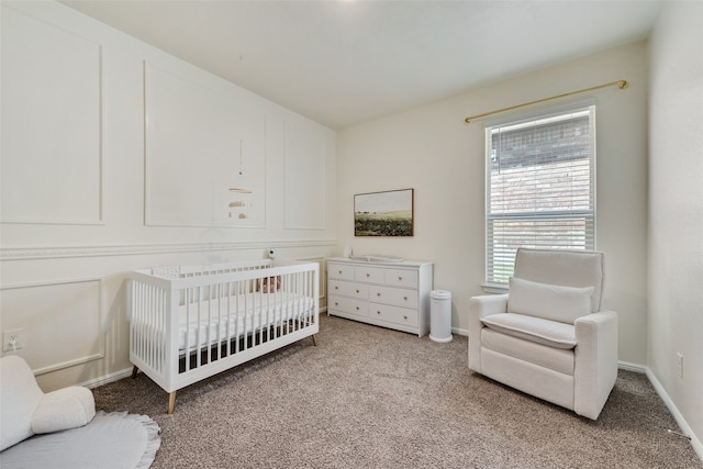 carpeted bedroom featuring a crib