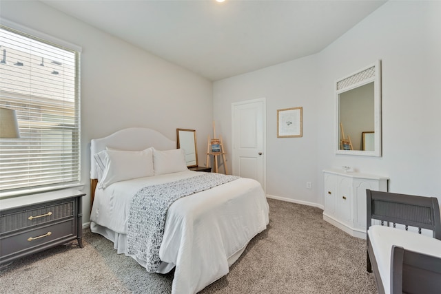 bedroom featuring light carpet