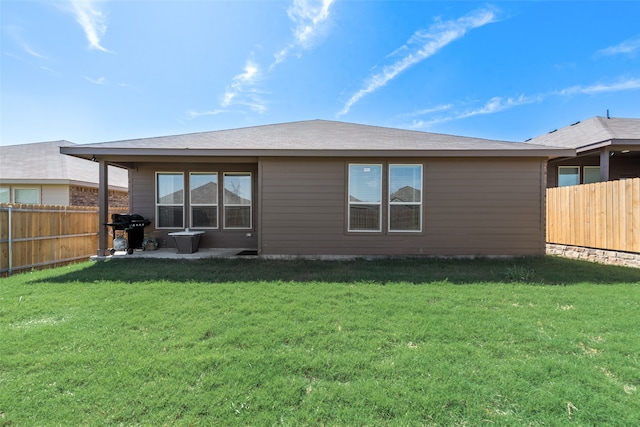 back of house featuring a yard