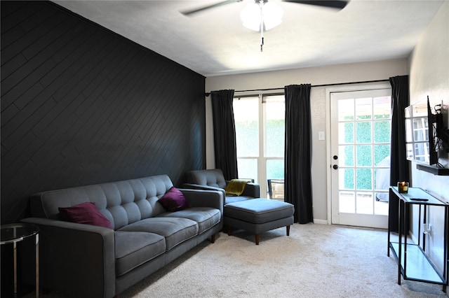 carpeted living room featuring ceiling fan