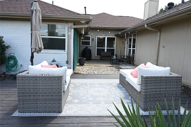 wooden terrace featuring a patio and an outdoor living space