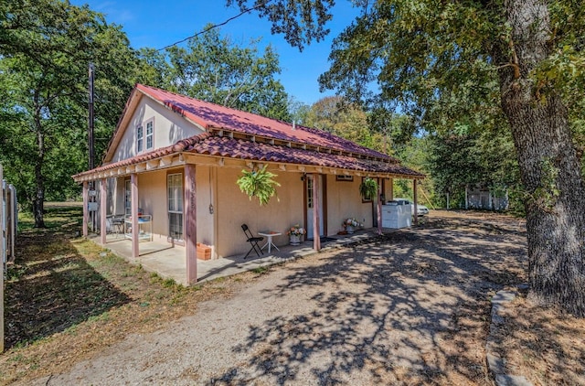 view of side of property with a patio