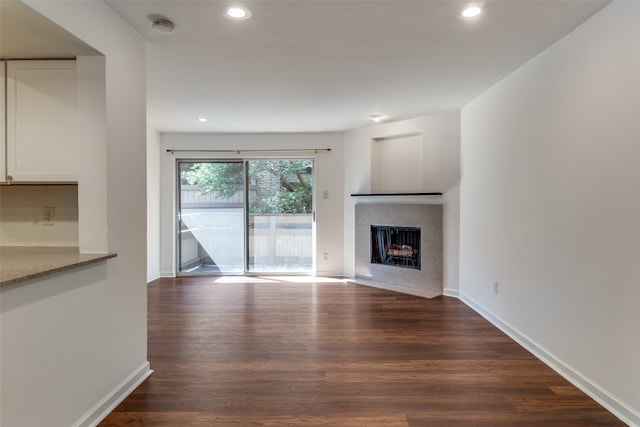 unfurnished living room featuring dark hardwood / wood-style floors