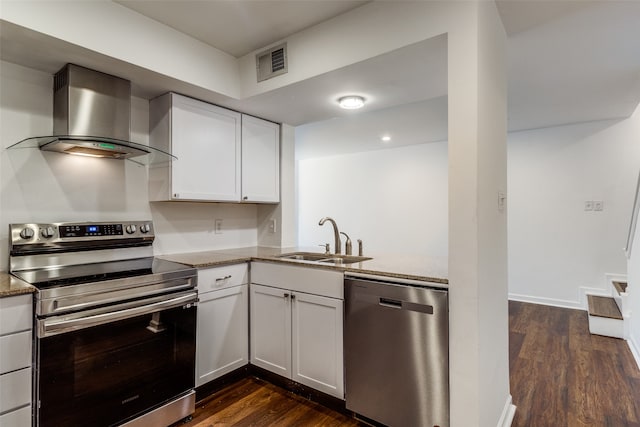 kitchen featuring wall chimney exhaust hood, sink, white cabinets, and stainless steel appliances