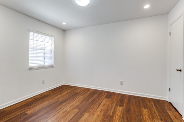 spare room featuring dark hardwood / wood-style flooring