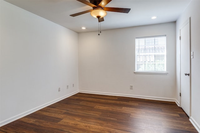 empty room with dark hardwood / wood-style floors and ceiling fan