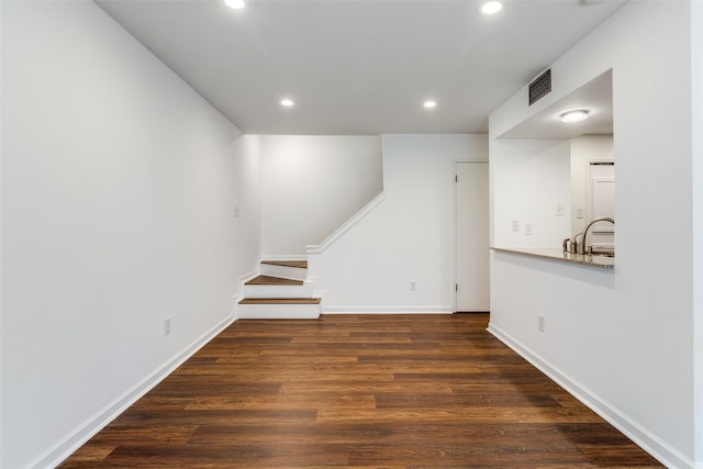 unfurnished living room with dark hardwood / wood-style flooring