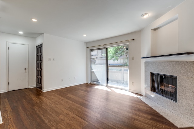 unfurnished living room with dark hardwood / wood-style floors