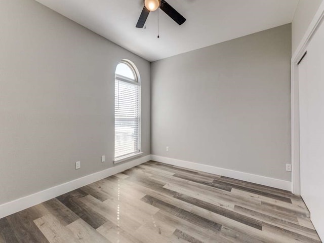 spare room with light wood-type flooring and ceiling fan