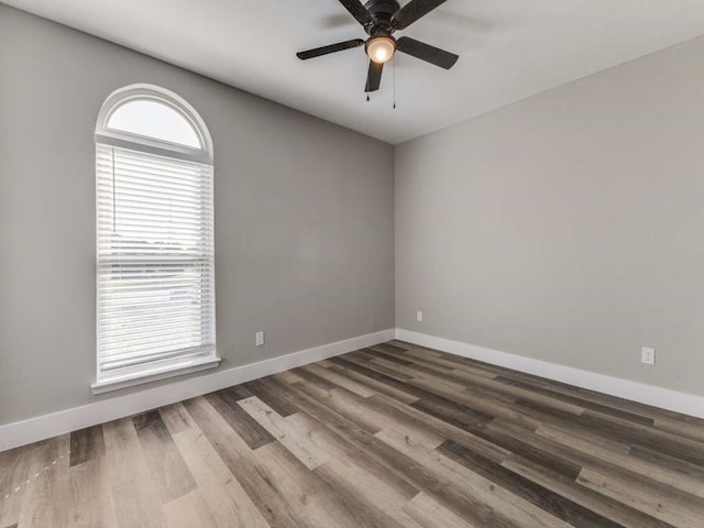 spare room with hardwood / wood-style floors, ceiling fan, and a wealth of natural light