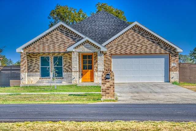 ranch-style house with a garage, fence, stone siding, brick siding, and concrete driveway