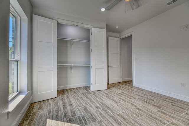 unfurnished bedroom with light hardwood / wood-style flooring, a closet, and ceiling fan