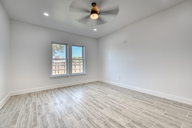 unfurnished room featuring light wood-style floors, baseboards, a ceiling fan, and recessed lighting