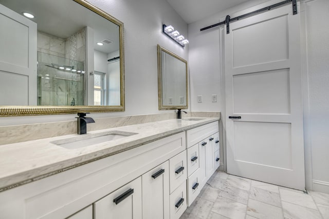 full bath featuring double vanity, a shower stall, a sink, and marble finish floor
