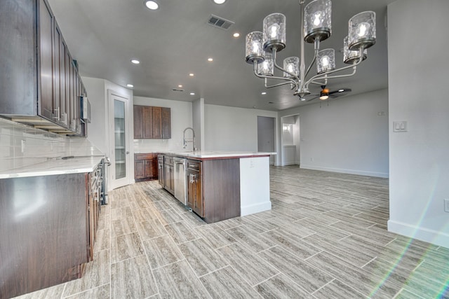 kitchen with an inviting chandelier, dishwasher, recessed lighting, baseboards, and visible vents