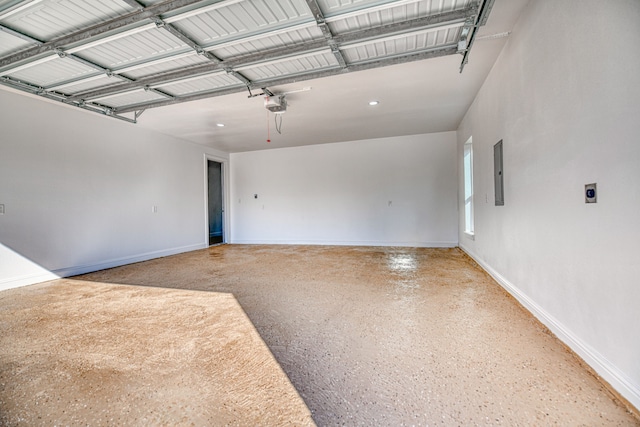 garage with a garage door opener and electric panel