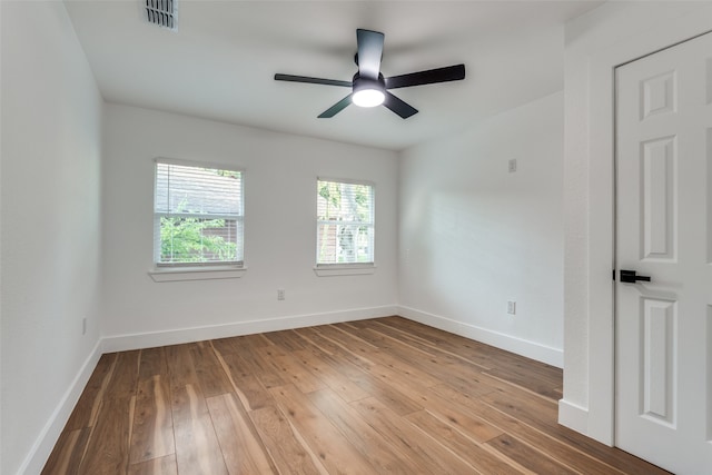 empty room with wood-type flooring and ceiling fan