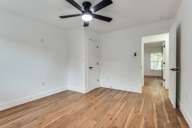 unfurnished bedroom with light hardwood / wood-style floors, a closet, and ceiling fan