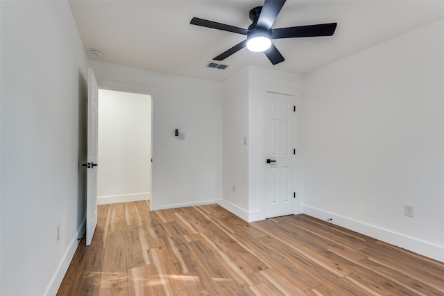 empty room featuring ceiling fan and light hardwood / wood-style flooring