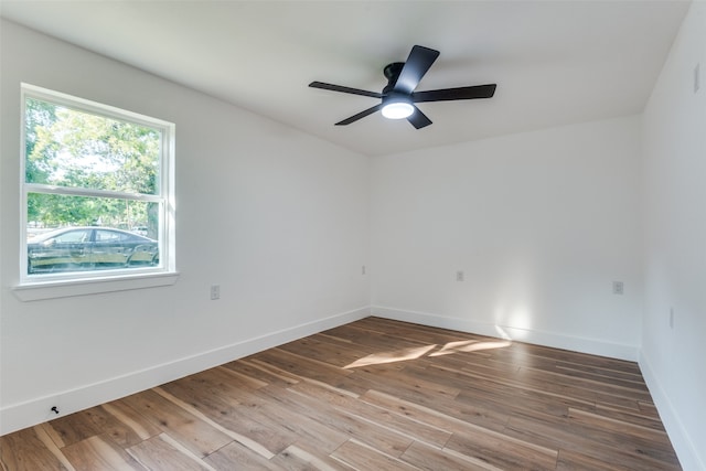 spare room with wood-type flooring and ceiling fan