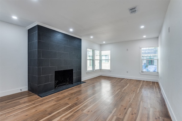 unfurnished living room with a fireplace and hardwood / wood-style floors