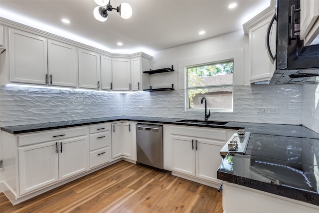 kitchen with light wood-type flooring, sink, stainless steel dishwasher, and white cabinets