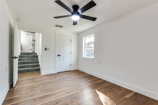 unfurnished bedroom featuring a closet, ceiling fan, and light hardwood / wood-style flooring