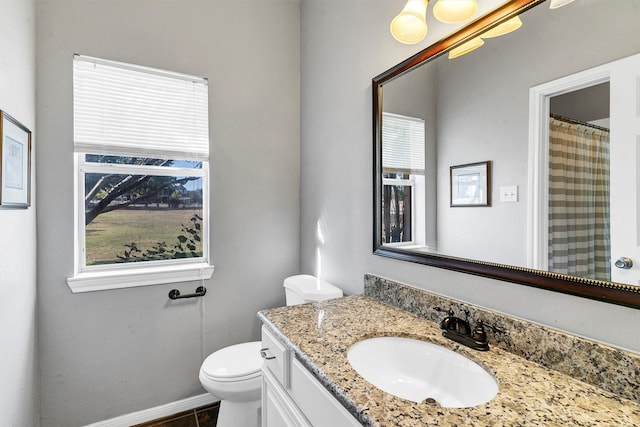 bathroom with vanity, toilet, and tile patterned flooring