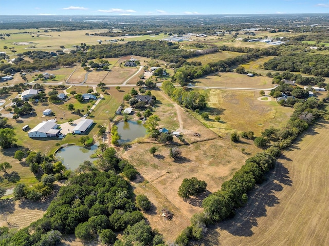 drone / aerial view featuring a water view and a rural view