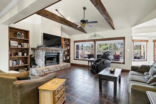 living room featuring ceiling fan, lofted ceiling with beams, plenty of natural light, and a stone fireplace