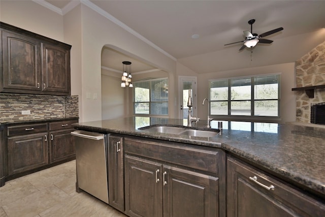 kitchen with dark brown cabinets, backsplash, dishwasher, ceiling fan with notable chandelier, and sink