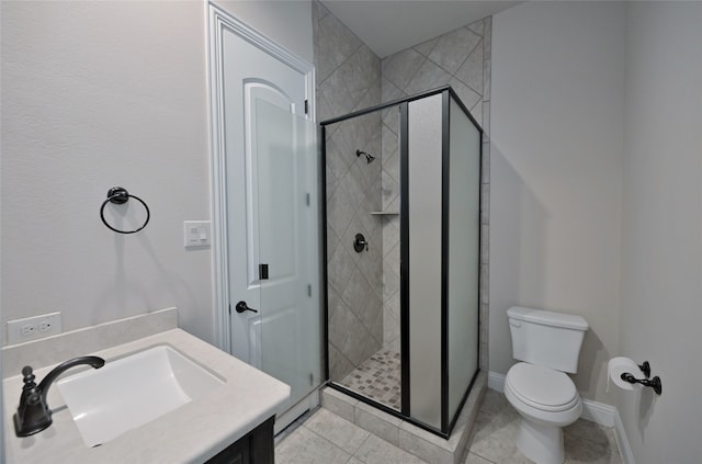 bathroom featuring vanity, toilet, and a shower with door