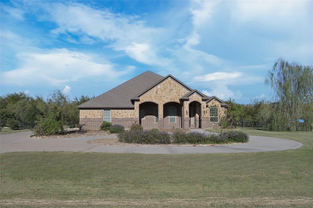4095 Bridgecreek Dr, Rockwall, TX 75032 - view of front of home with brick siding, stone siding, and a front lawn