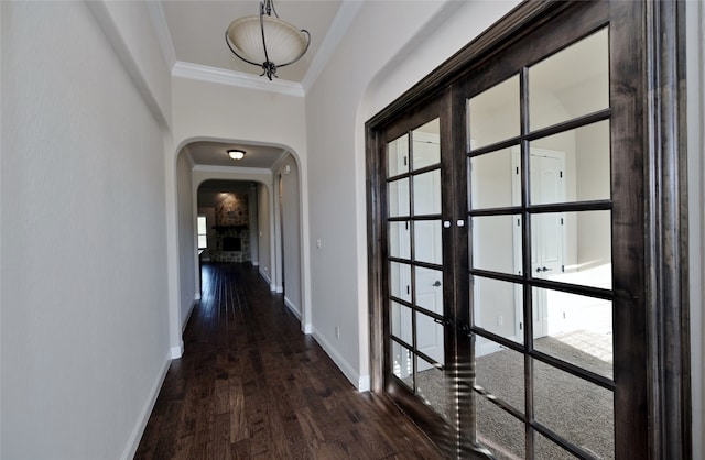 hall with crown molding, dark hardwood / wood-style floors, and french doors