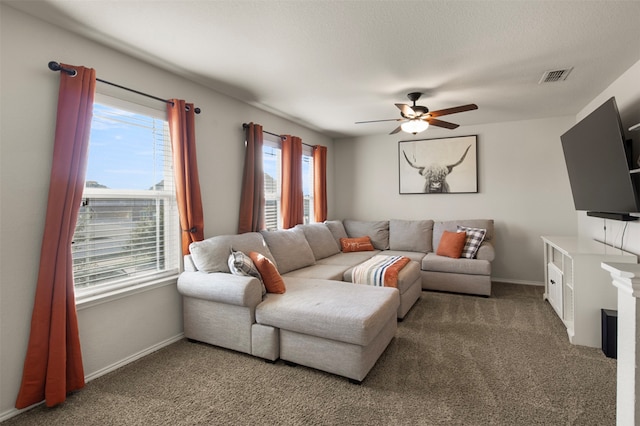 living room featuring ceiling fan, a textured ceiling, and carpet floors