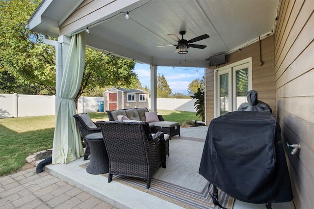 view of patio featuring a storage shed, grilling area, and ceiling fan