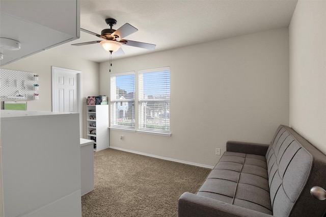 carpeted living room with ceiling fan