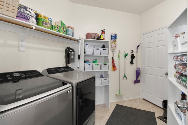 washroom with light tile patterned floors and separate washer and dryer