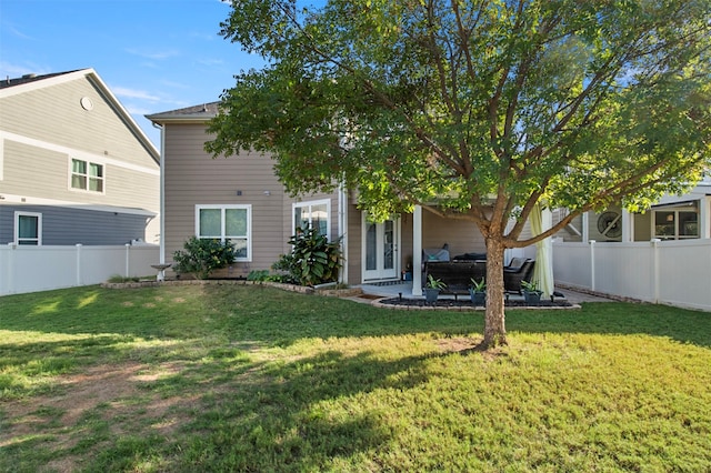 rear view of property with a patio area and a yard