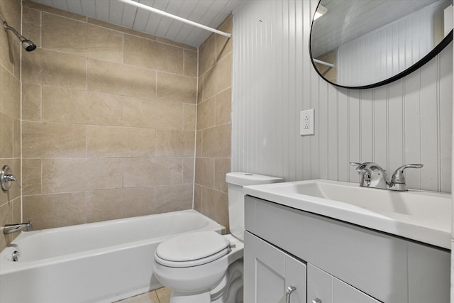 full bathroom with tiled shower / bath, vanity, wooden walls, and toilet